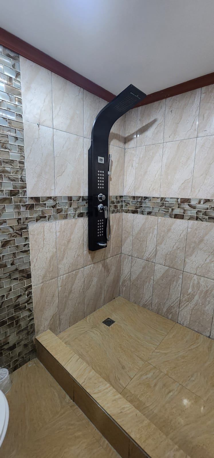 Tiled bathroom with shower panel