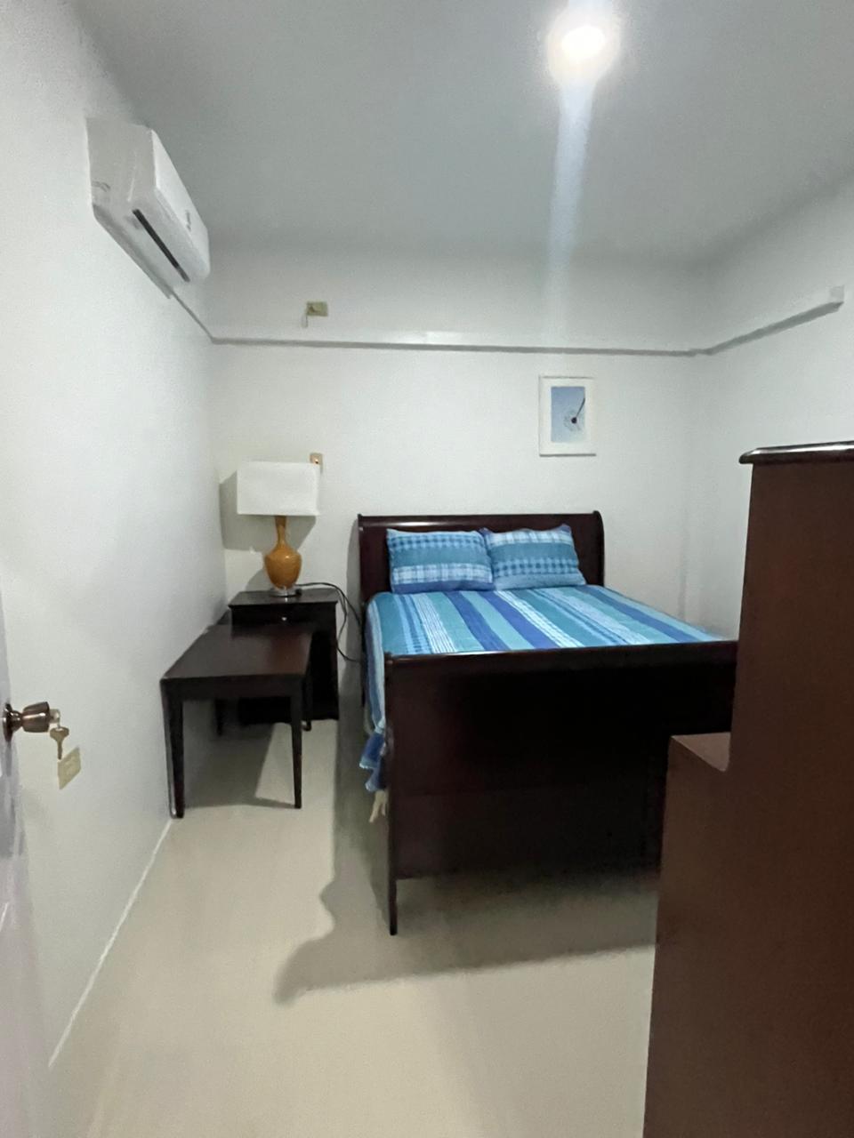Bedroom with sleigh bed, work desk and air conditioning