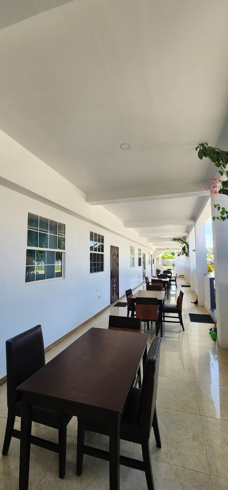 Covered dining terrace with tables and chairs
