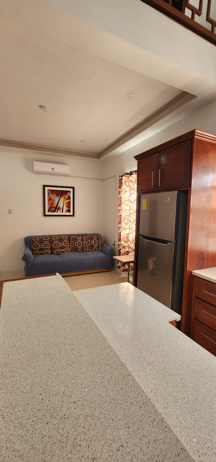One-bedroom apartment kitchen, living area and refrigerator